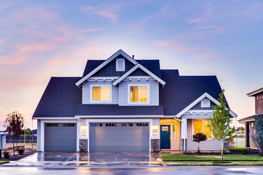blue house with lights on pink and blue sky