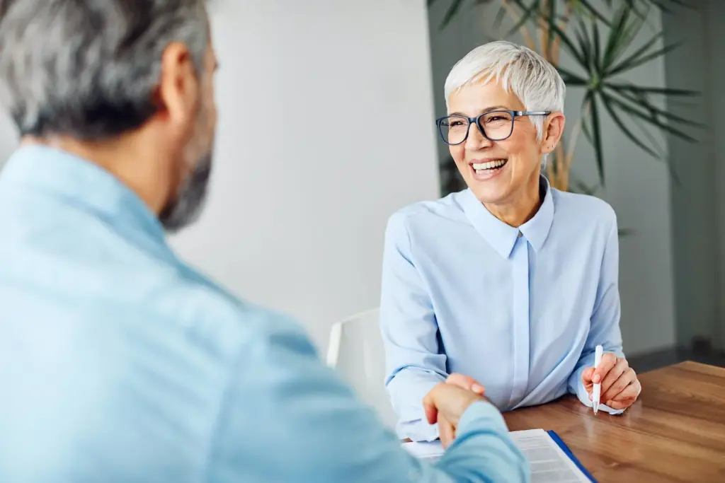 woman shaking hands with a man